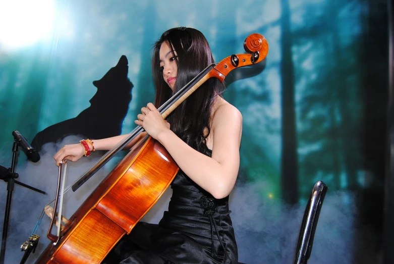 a woman in a black dress playing a cello, inspired by Chen Yifei, flickr, a beautiful kitsune woman, asian girl with long hair, half - length photo, photo-shopped