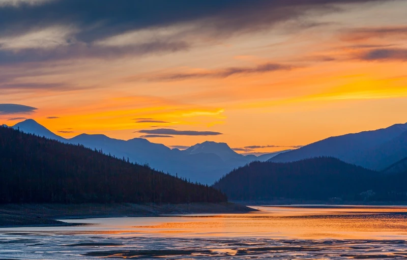 a large body of water with mountains in the background, by Raymond Normand, shutterstock, fine art, the colours of the sunset, yeg, cascade, sigma 1/6