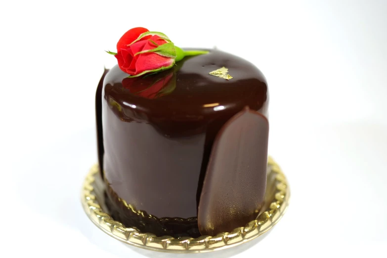 a chocolate cake with a single rose on top, by Arthur Sarkissian, rasquache, high detail product photo, glazed, very sharp and detailed photo, product introduction photo