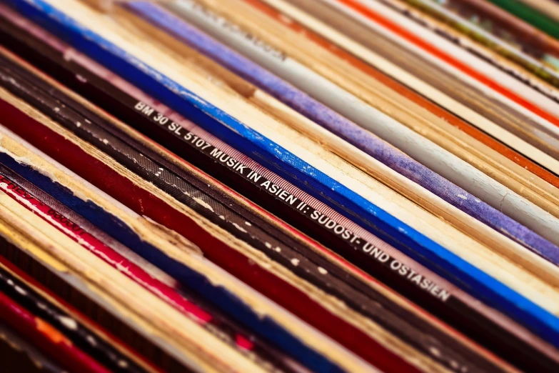 a bunch of different colored pencils sitting on top of each other, an album cover, by Thomas Häfner, synthetism, rack focus, vinyl records, barcodes, vintage old