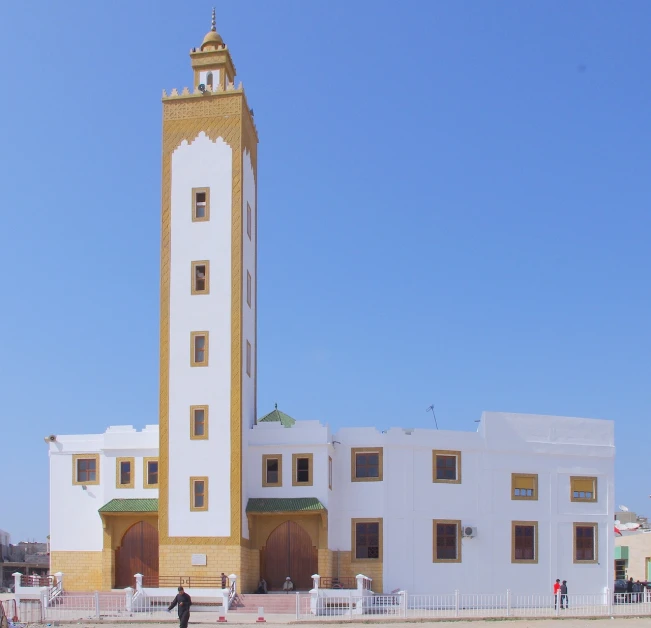 a white and yellow building with a clock tower, inspired by Alberto Morrocco, tuareg, very wide view, mosque, farol da barra
