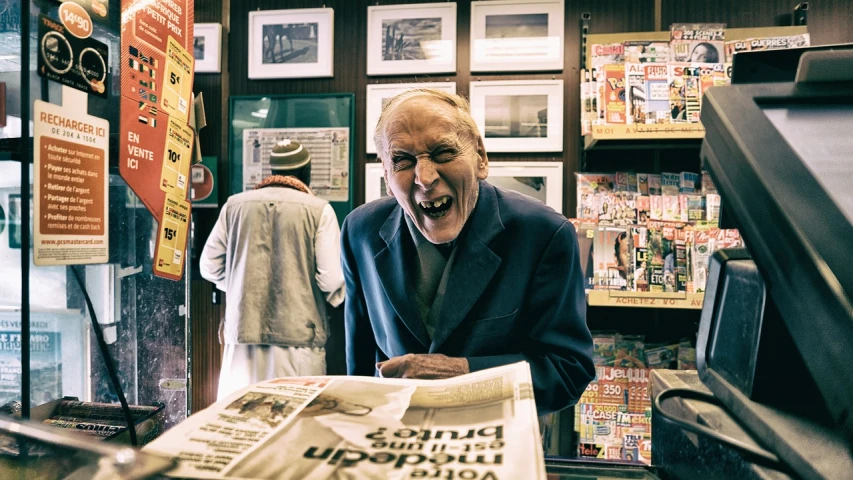 a man sitting at a table with a newspaper in front of him, a picture, by Joe Bowler, pexels contest winner, private press, old lady screaming and laughing, old retro museum exhibition, stood outside a corner shop, ian callum!