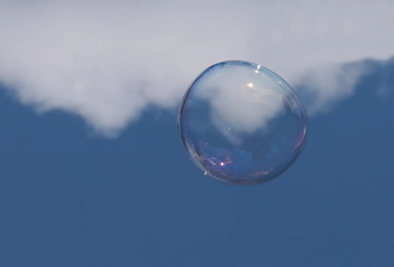 a bubble floating in the air with a cloud in the background, medium closeup shot, high quality product image”