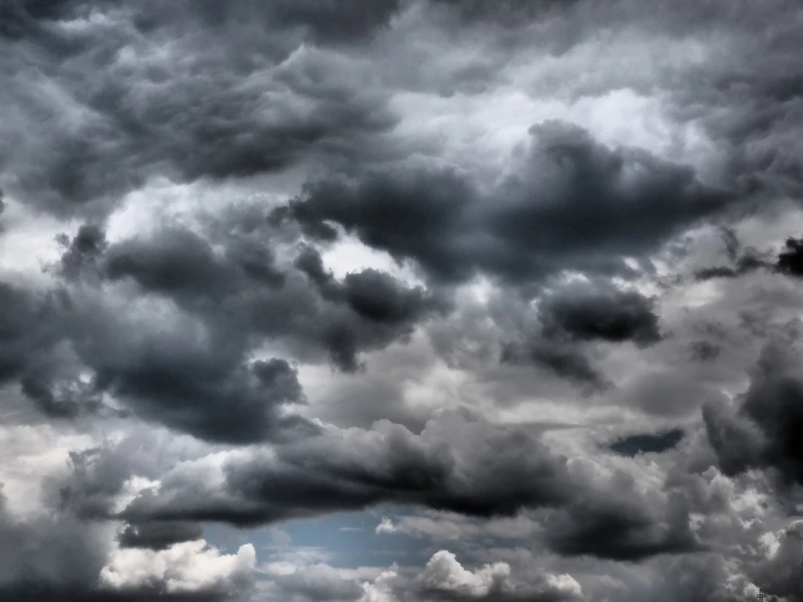 a plane is flying through a cloudy sky, a picture, by Kazimierz Wojniakowski, vorticism, dark mammatus cloud, “puffy cloudscape, intense dramatic hdr, grey