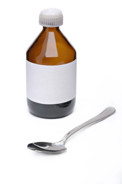 a bottle of medicine with a spoon next to it, purism, dezeen, beer bottle, joseph todorovitch, professional product photo