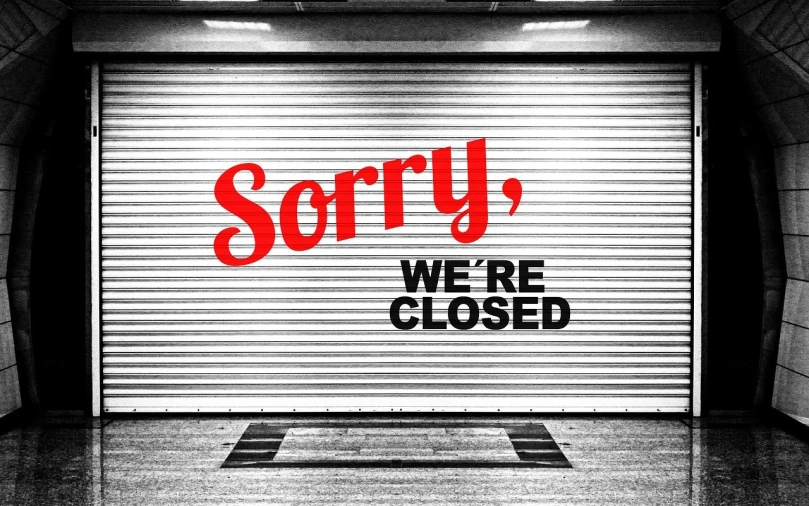 a closed garage door that says sorry we're closed, a photo, shutterstock, shuttered mall store, background image, clemens ascher, document photo