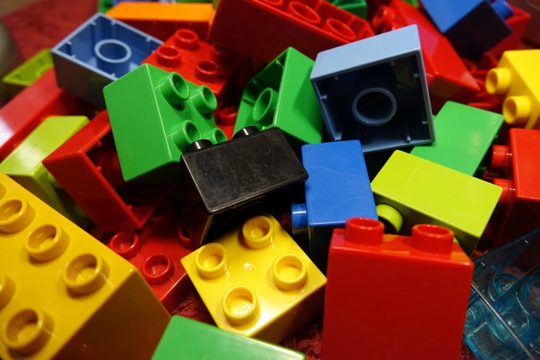a pile of lego blocks sitting on top of a table, a picture, pexels, modular constructivism, viewed from below, full of colour w 1024, deep colour\'s, color slide