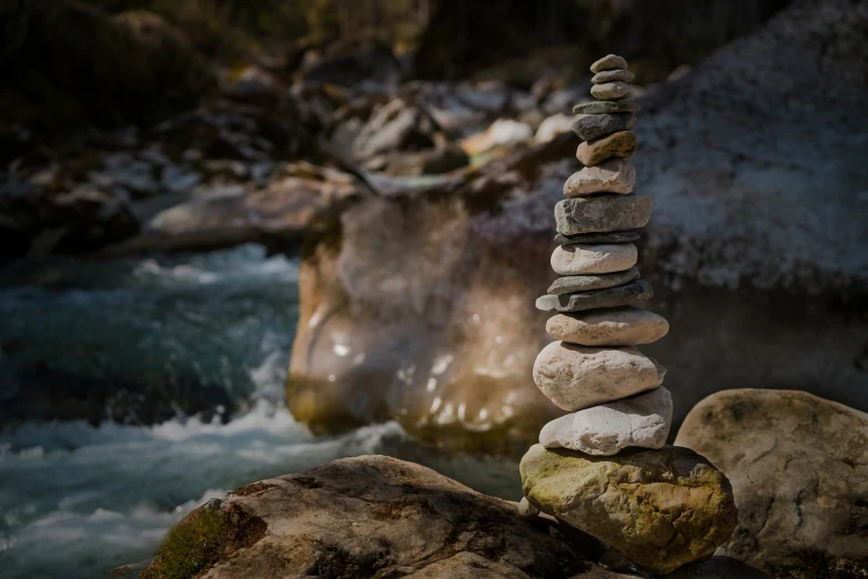 a pile of rocks sitting on top of a river, a marble sculpture, by Franz Hegi, unsplash, totem, paul barson, switzerland, rock painting