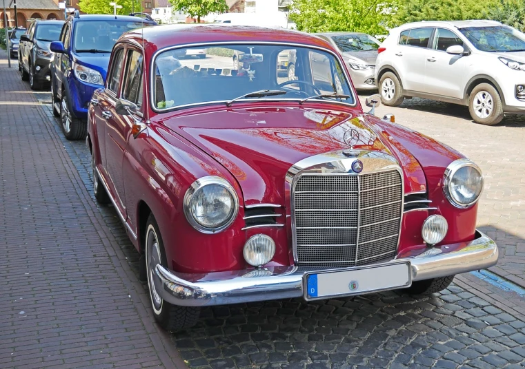 a red car parked on the side of the road, by Hans Fischer, trending on pixabay, modernism, mercedes, antique style, symmetrical front, vintage - w 1 0 2 4