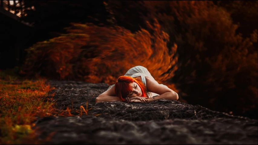 a woman with red hair laying on the ground, inspired by Brooke Shaden, tumblr, digital art, beautiful lava landscape, orange halo, beautiful avatar pictures, asleep