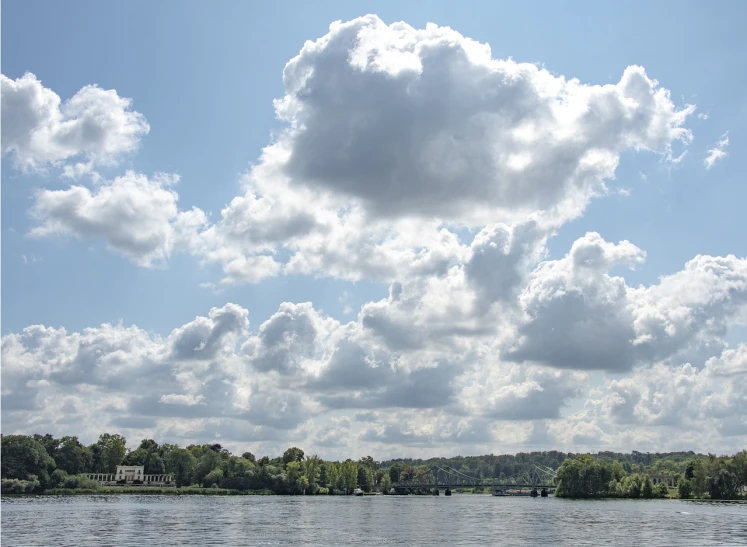 a large body of water with a bunch of clouds in the sky, by Karl Hagedorn, flickr, thames river, washington dc, round clouds, low ultrawide shot