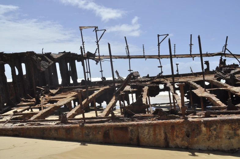 a rusted ship sitting on top of a sandy beach, renaissance, building destroyed, many rusty joints, te pae, detaild