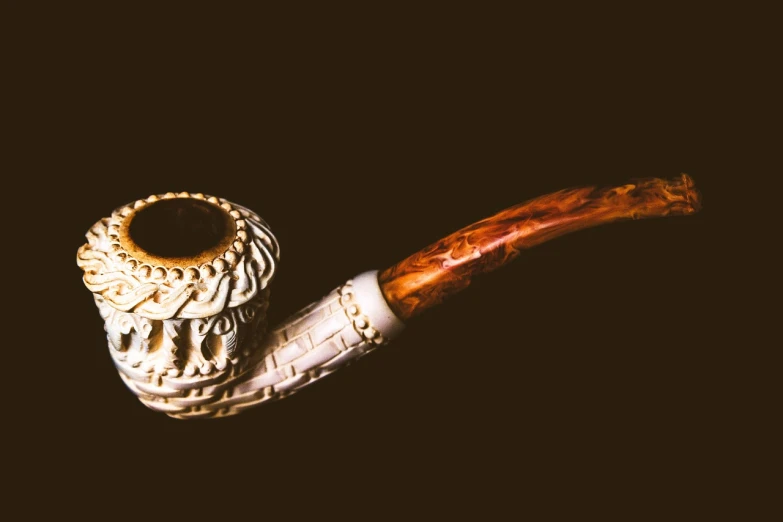 a pipe sitting on top of a wooden table, a macro photograph, inspired by Muirhead Bone, baroque, high detail product photo