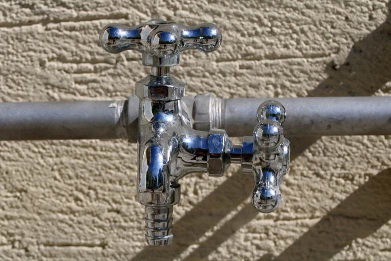a close up of a faucet attached to a wall, flickr, chrome tubes, bay area, clear detailed view, high details photo