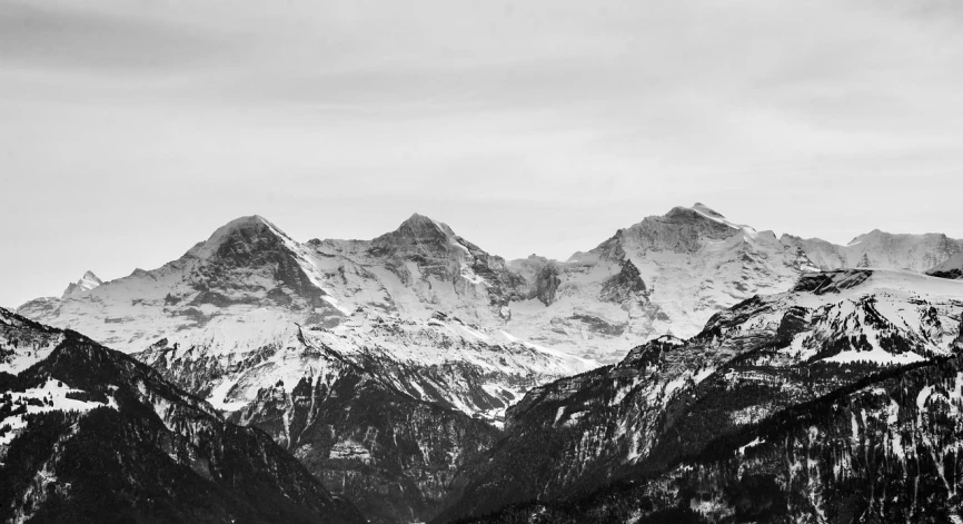 a black and white photo of a mountain range, by Matthias Weischer, pexels, fine art, phone wallpaper, swiss alps, winter, colorless