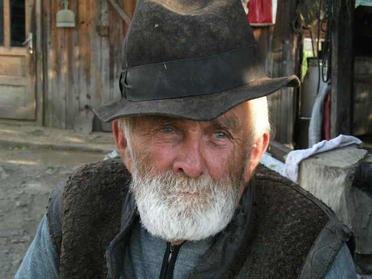 a close up of a person wearing a hat, by Jan Konůpek, farmer, short white beard, avatar image, years old