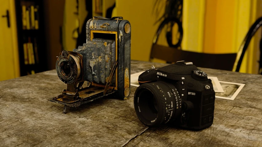 a camera sitting on top of a wooden table, a picture, by Mathias Kollros, flickr contest winner, art photography, weathered artifacts, front and side view, repairing the other one, yellowed with age