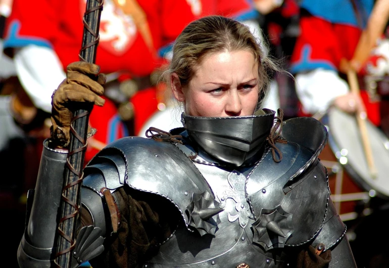 a woman dressed in armor holding a sword, flickr, battle - weary, knights in battle, wearing steel collar, celebrating