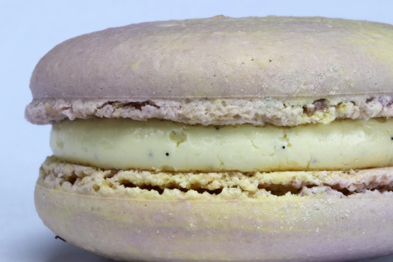 a close up of a macaron on a white surface, a pastel, by Dietmar Damerau, flickr, it has lemon skin texture, open, mcdonald, rocket