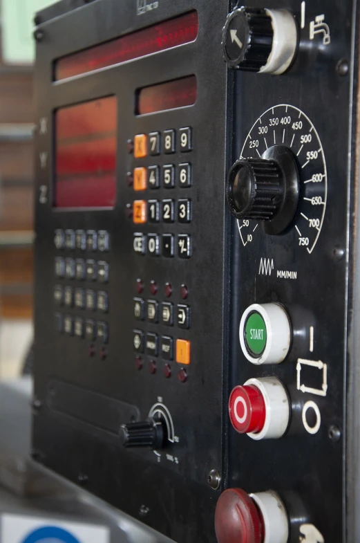 a close up of a control panel on a machine, a portrait, 90s photo, factory background, high details photo