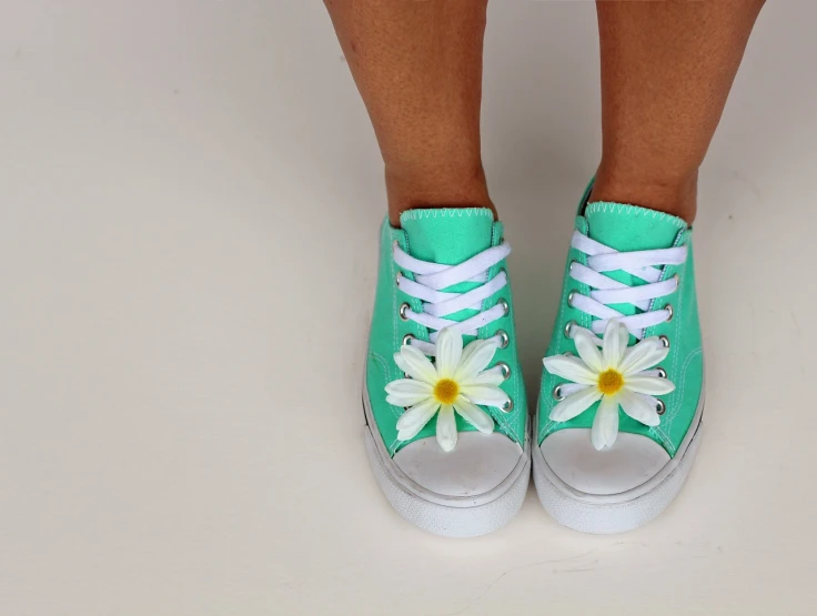 a close up of a person's shoes with flowers on them, by Rhea Carmi, sea - green and white clothes, daisy, white background : 3, teenager girl