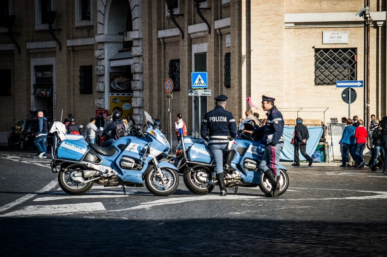 two police officers on motorcycles on a city street, a photo, by Alessandro Allori, high resolution photo, in a row, light blues, police man!!