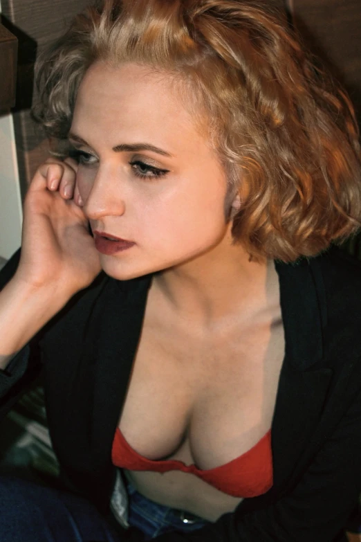 a close up of a woman talking on a cell phone, inspired by Nan Goldin, tumblr, photorealism, short curly blonde haired girl, cleavage, joey king, britt marling style 3 / 4