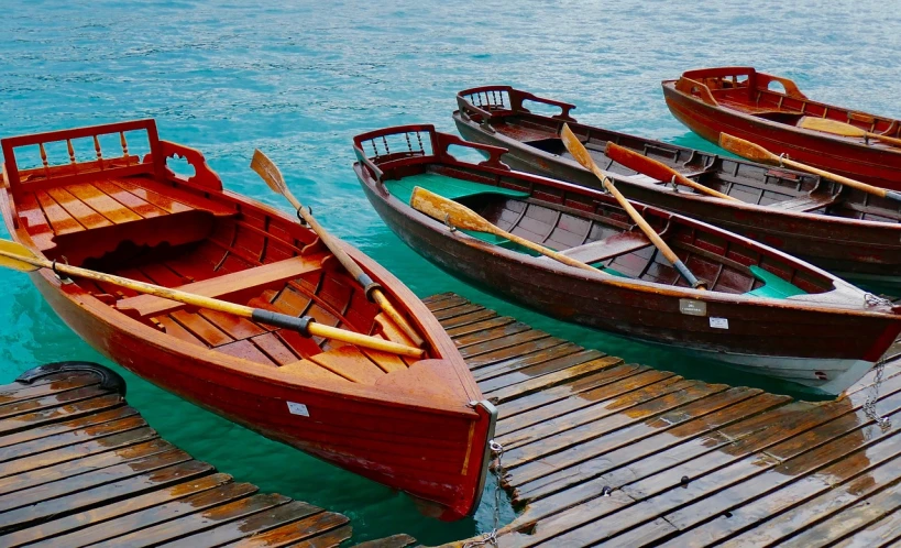 a group of boats sitting on top of a wooden dock, by Franz Hegi, shutterstock, fine art, varnished, rowing boat, wide screenshot, test