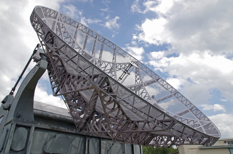 a large satellite dish sitting on top of a building, by Jon Coffelt, flickr, hyperdetailed metalwork, metallic bridge, ancient megastructure pyramid, close up shot from the side