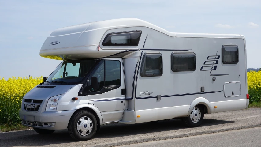 a motor home parked on the side of the road, a photo, by Julian Allen, shutterstock, wikimedia, frontal pose, flat grey, france