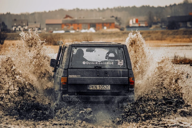 a car driving through a puddle of water, a picture, by Dietmar Damerau, unsplash, off-roading, nostalgic 8k, battle action shot, swedish style