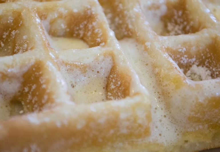 a close up of a waffle on a plate, by Jason Felix, foamy waves, older male, ohio, start