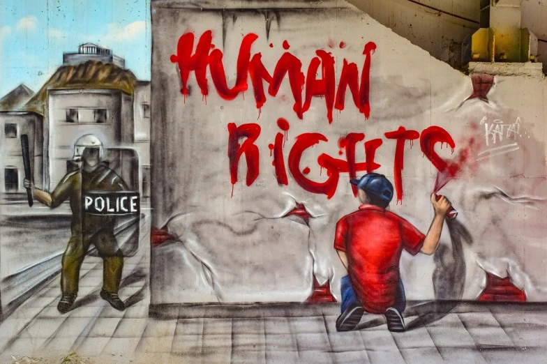 a man painting a mural on the side of a building, graffiti art, by Luis Molinari, shutterstock, human prisoners, police state, official artwork hdr, gay rights