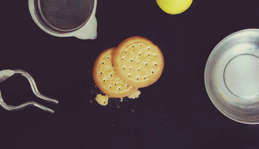 a couple of crackers sitting on top of a table, inspired by Leo Leuppi, lemon, instagram picture, 38mm photography, pie eyes