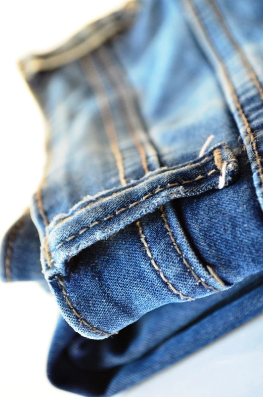 a close up of a pair of blue jeans, a picture, happening, closeup photo, soft light, damaged clothes, mid shot photo