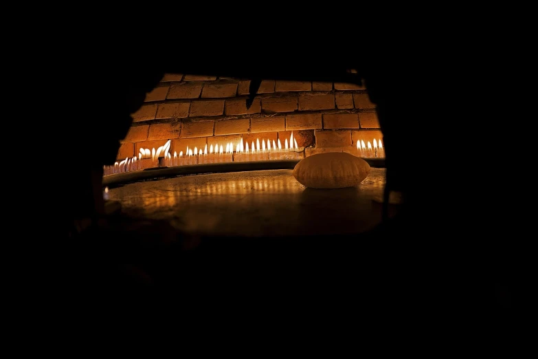 a fireplace with lit candles in a dark room, a picture, flickr, buddhist monastery on mars, cave reflecting in the lava lake, taken with my nikon d 3, view from the side”