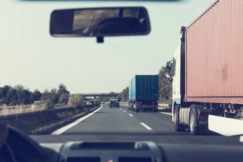 a view from the driver's seat of a truck driving down a highway, a picture, shipping containers, istock, traffic accident, view from behind mirror