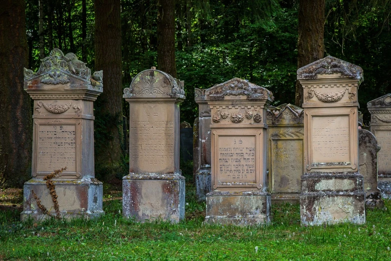 a group of tombstones sitting on top of a lush green field, by Jacob Steinhardt, hebrew, in scotland, placed in a lush forest, victorian