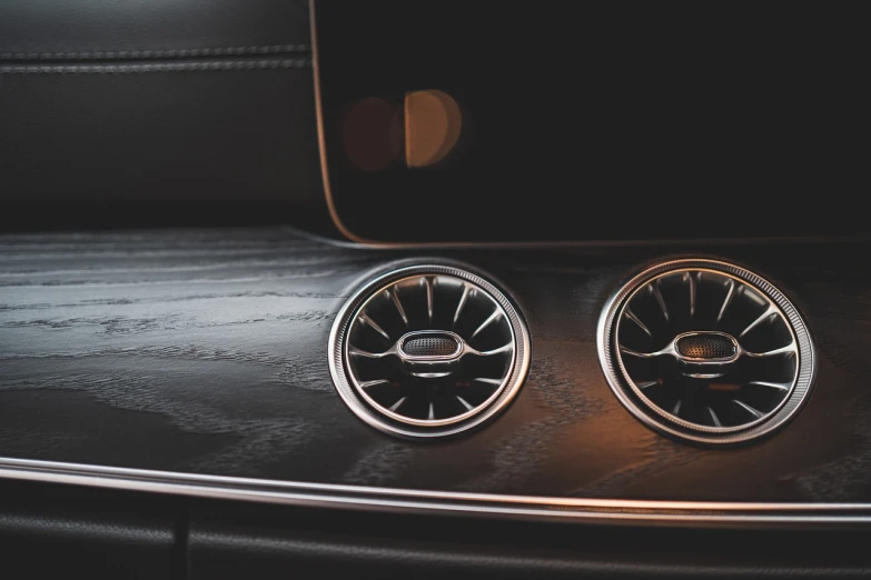 a pair of speakers sitting on top of a wooden table, by Thomas Häfner, unsplash, auto-destructive art, mercedez benz, tactile buttons and lights, modern car design, leather interior