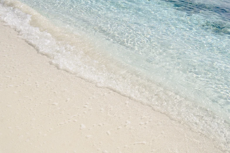 a person riding a surfboard on top of a sandy beach, by Richard Carline, water texture, bahamas, detailed white liquid, very very well detailed image