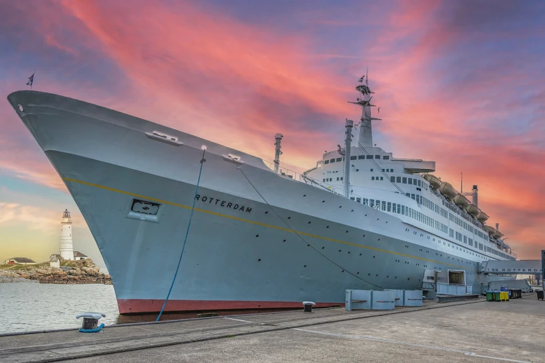 a large white ship sitting on top of a body of water, by Robert Brackman, shutterstock, modernism, docked at harbor, sunset!, tourist photo, under repairs