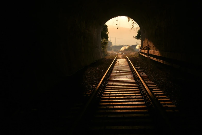 a train is coming out of a tunnel, a picture, shutterstock, romanticism, contre - jour, catwalk, motivational, dawn light
