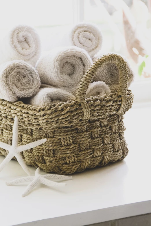 a basket filled with towels sitting on top of a counter, renaissance, starfish, middle close up composition, professional product photo, istockphoto