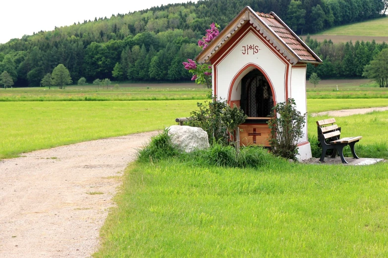a small white house sitting on top of a lush green field, by Franz Hegi, flickr, renaissance, stone pews, reliquary, roadside, well decorated