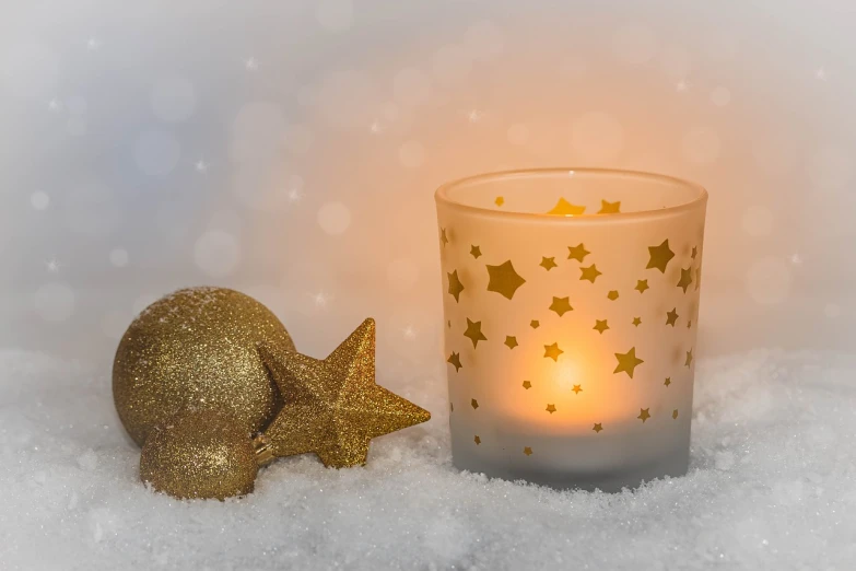 a candle that is sitting in the snow, inspired by Rudolph F. Ingerle, pixabay, glittering stars scattered about, golden ornaments, 🕹️ 😎 🔫 🤖 🚬, frosted glass