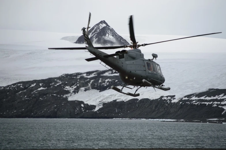 a helicopter flying over a body of water, by Jens Søndergaard, flickr, hurufiyya, an ice volcano, us airforce, modern high sharpness photo, stock photo