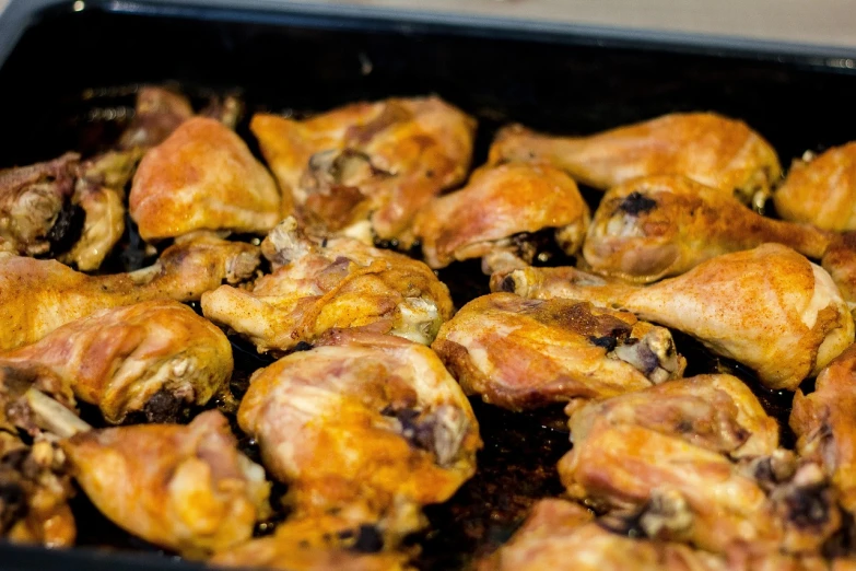 a pan filled with chicken wings sitting on top of a stove, by Nándor Katona, figuration libre, closeup of arms, chilean, leftover meat pie, transparent background