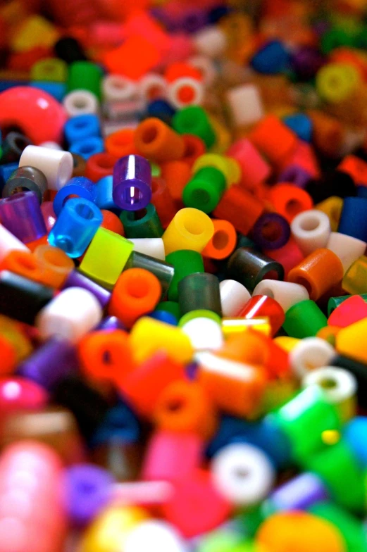 a pile of colorful beads sitting on top of a table, a macro photograph, by David Burton-Richardson, flickr, pointillism, tubes, cubes, bright macro view pixar, hollow