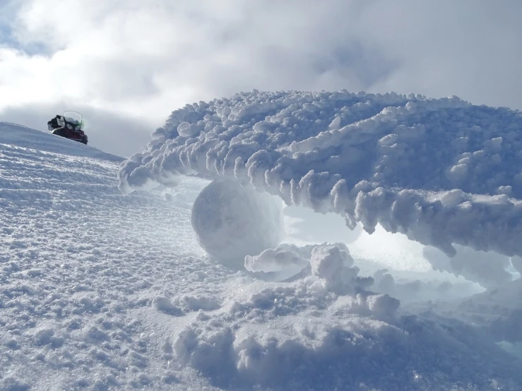 a man riding a snowboard down a snow covered slope, by Anna Haifisch, land art, cloud in the shape of a dragon, sphere, ice gate, closeup - view