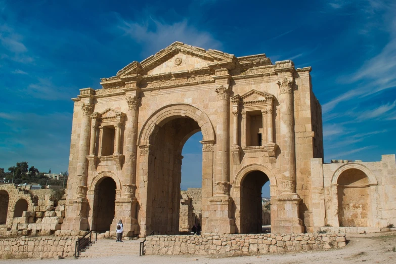 a man that is standing in front of a building, by Edmond Aman-Jean, pixabay, neoclassicism, huge giant old ruins, arch, jordan, large gate